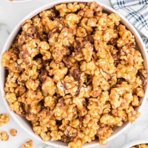 Snickers Popcorn in a white bowl.