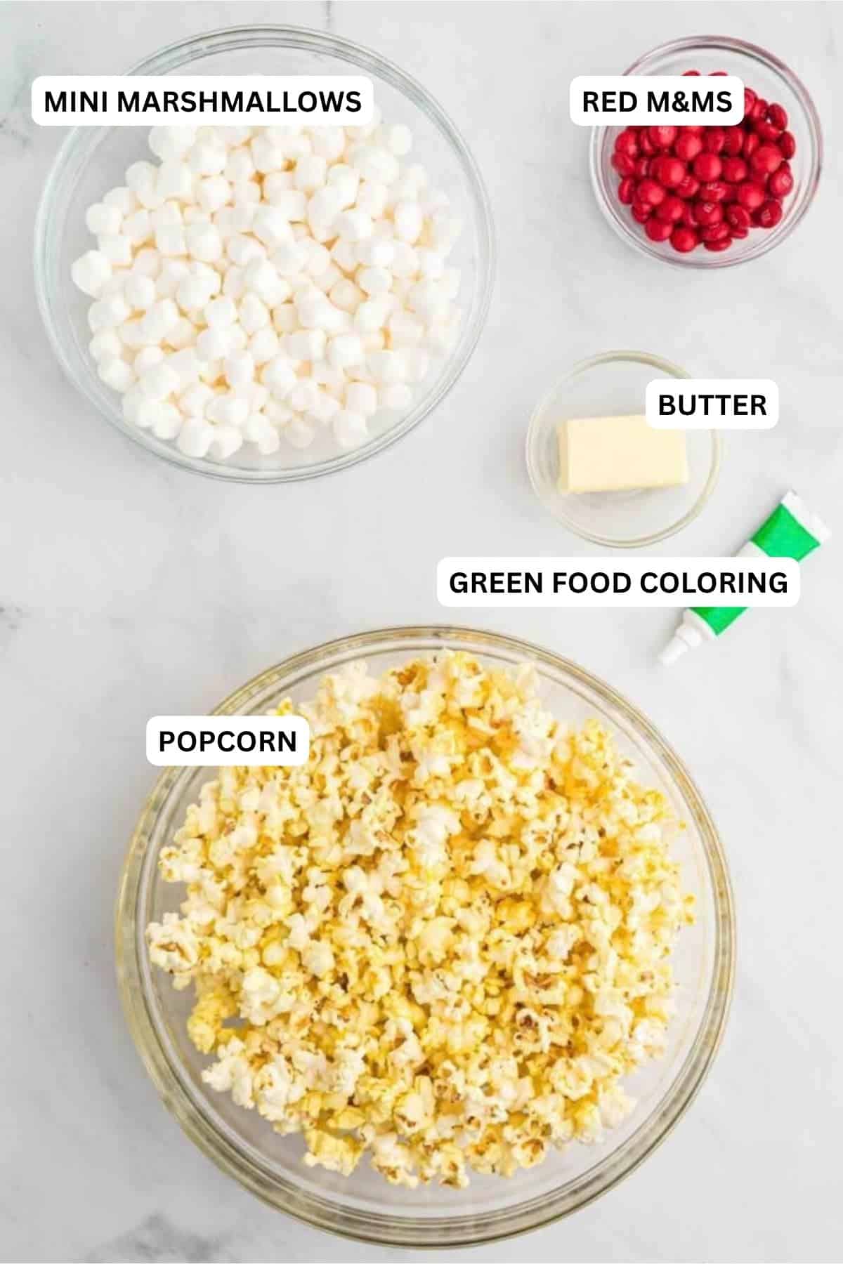 Ingredients for recipe: mini marshmallows, red M&M's, butter, green food coloring and popcorn.