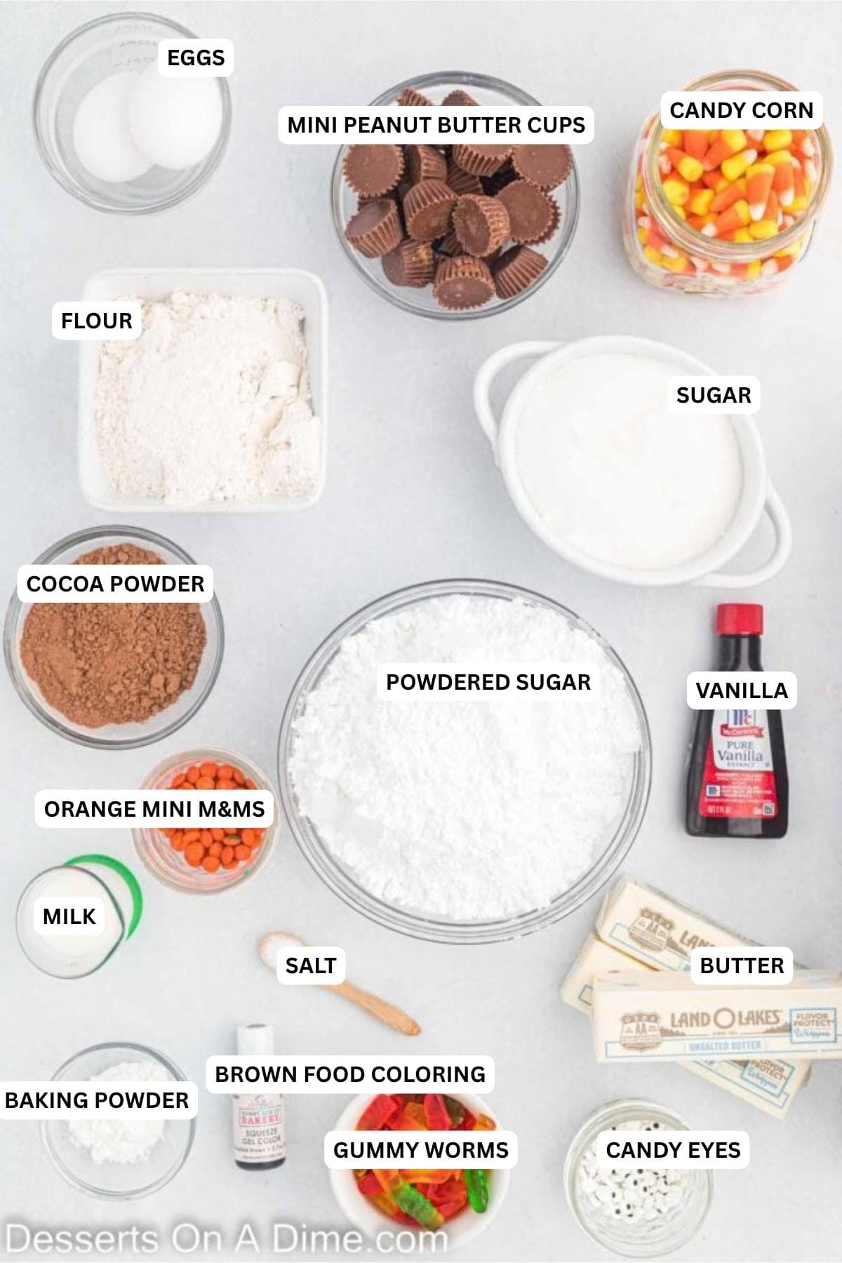 Ingredients for recipe: flour, butter, egg, egg yolk, vanilla, powdered sugar, cocoa powder, sugar, baking powder, salt, milk, mini reese's cups, candy eyes, gummy worms, candy corn. mini orange M&M's. 