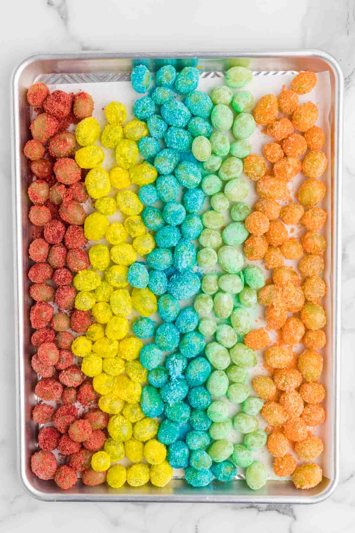 Sour patch grapes on a cookie sheet.