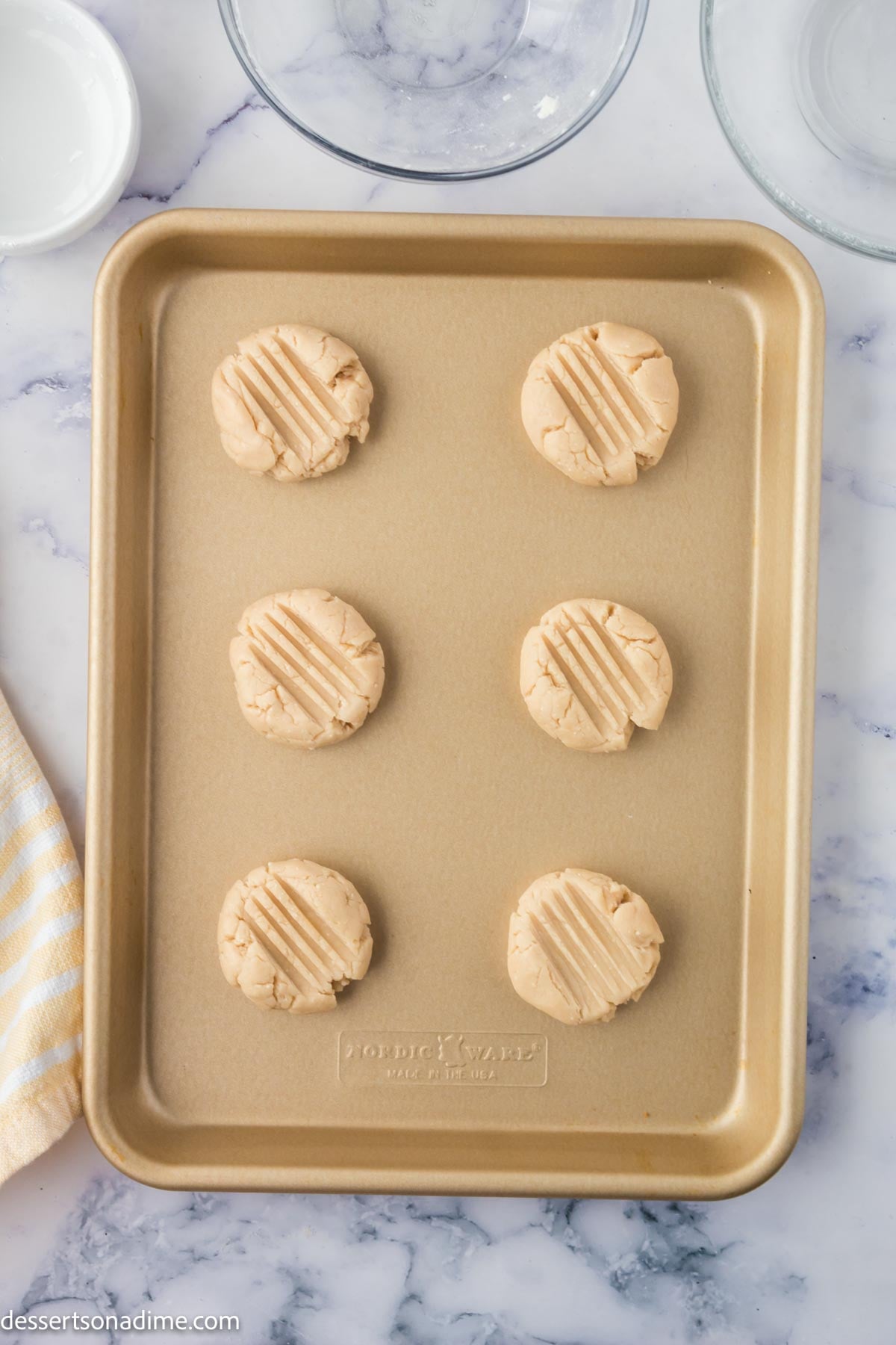 Dough shaped into cookies and placed on baking sheet. 