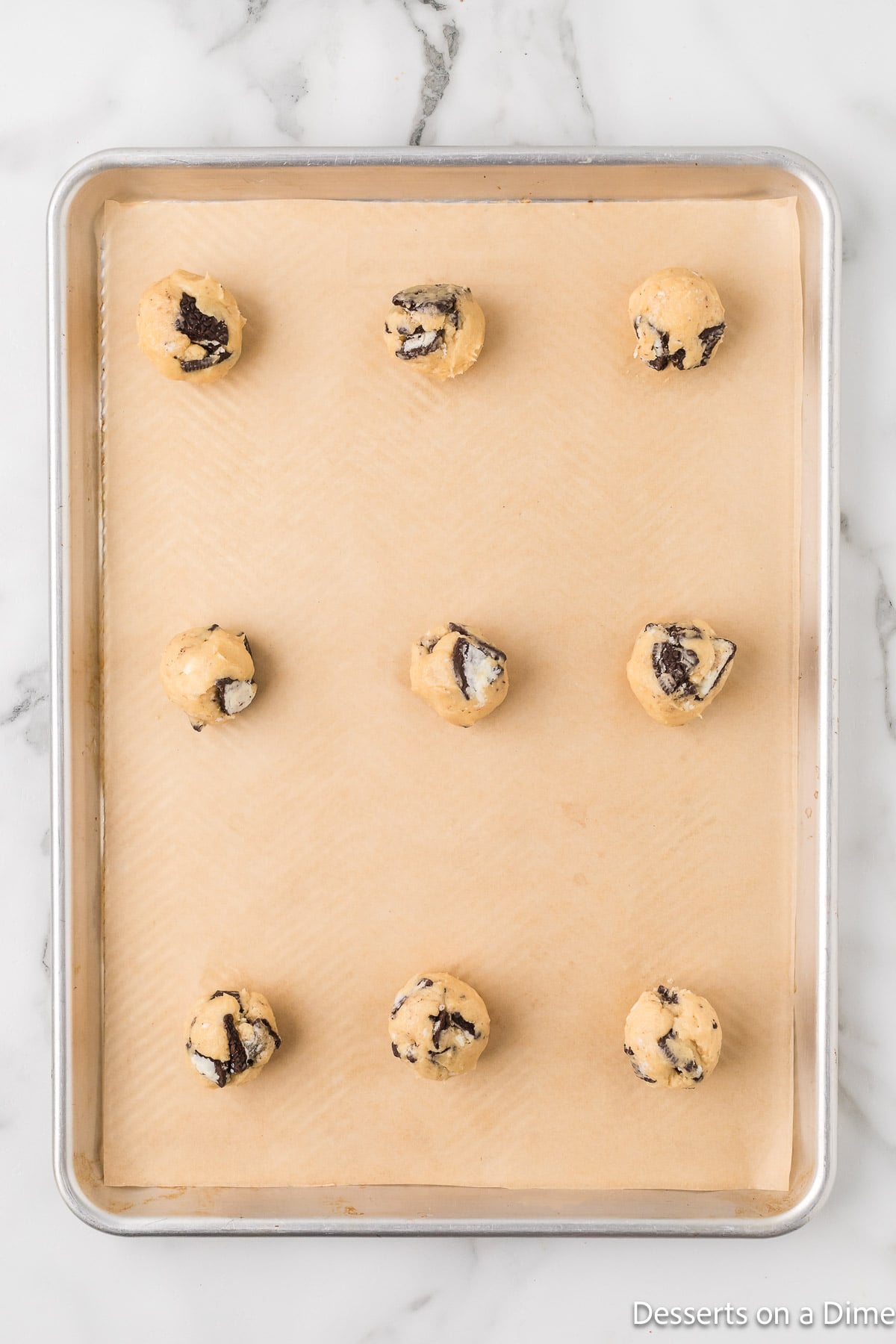 Cookies formed into balls and placed on baking sheet. 