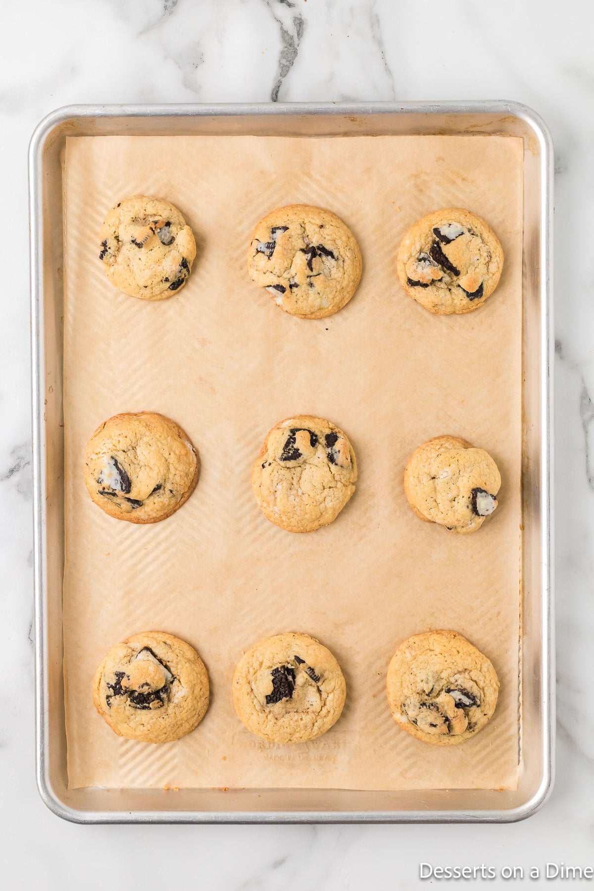 Cookies baked and cooling on baking sheet. 
