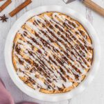 Cinnamon roll pie with glaze on top.