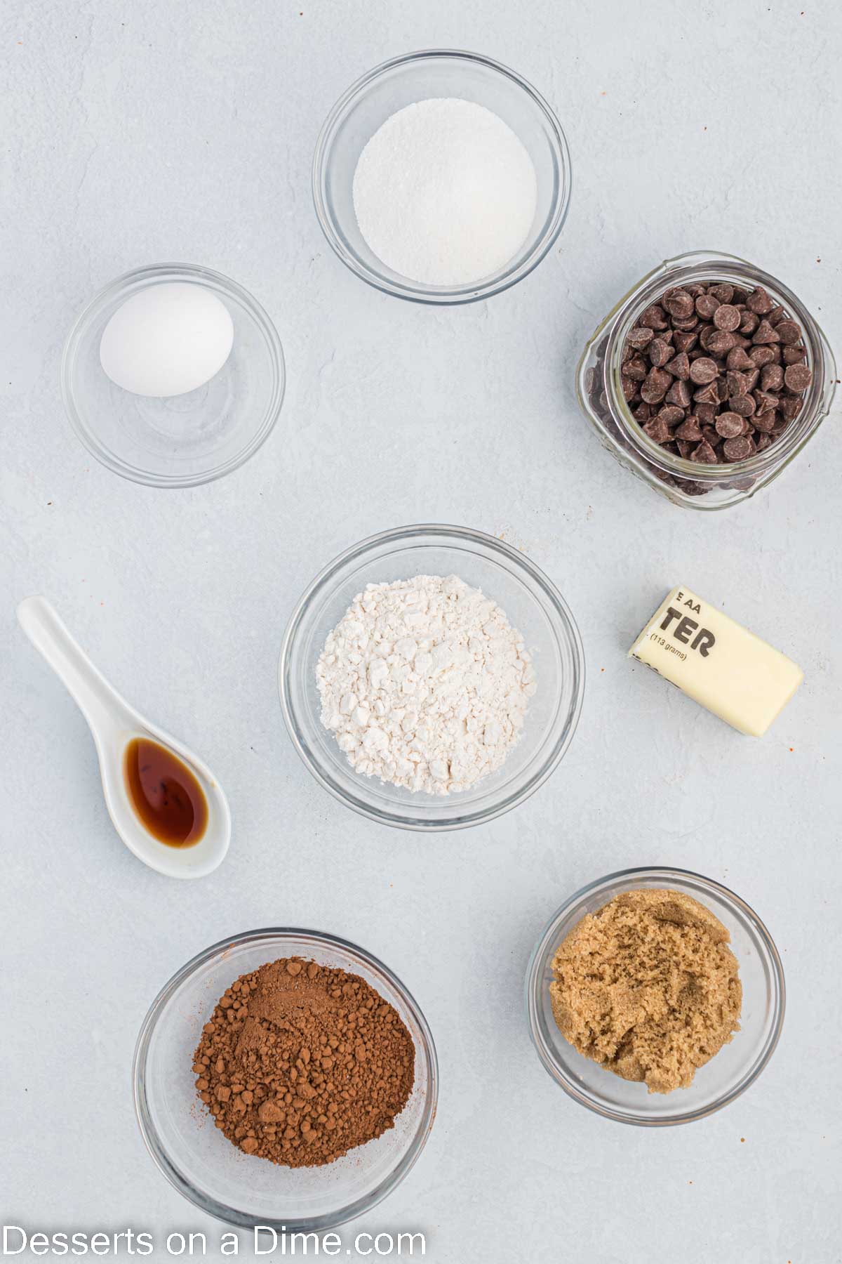 Ingredients for air fryer brownies - brown sugar, cocoa powder, chocolate chips, vanilla, butter.