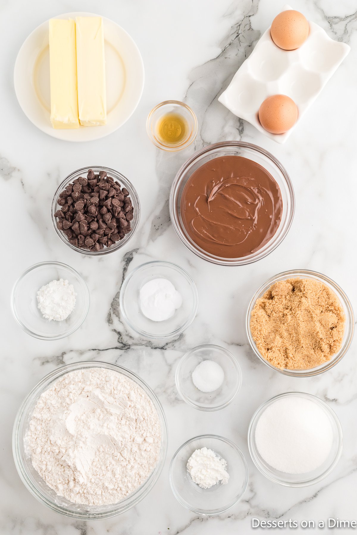 Ingredients for Nutella stuffed cookies - butter, nutella, brown sugar, eggs, vanilla, baking soda, flour, chocolate chips. 