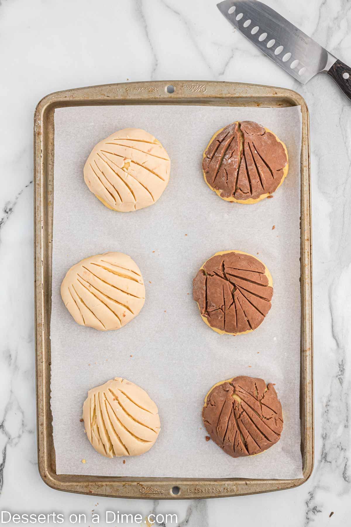 Topping placed on dough balls and marked with shell pattern. 