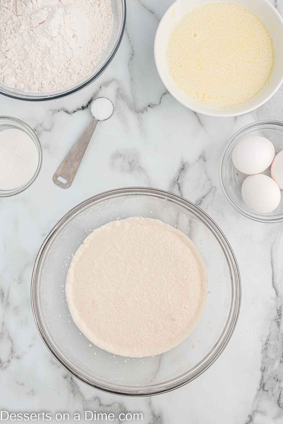 Mixing bowl with yeast and sugar. 