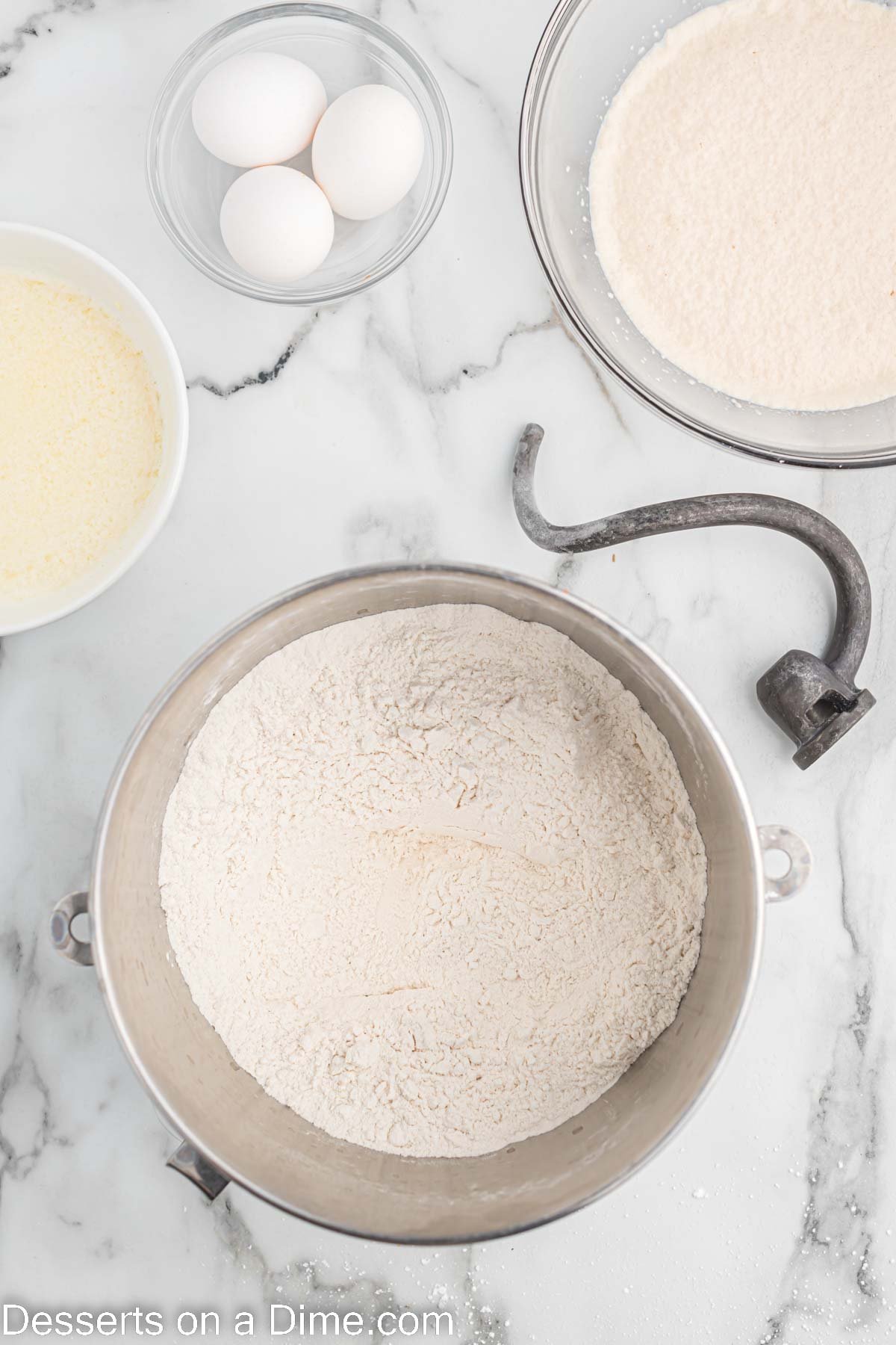 Flour added to yeast mixture in bowl. 