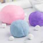 Pink, purple, and blue cotton candy sugar balls, colorful sweet treats for dessert lovers.