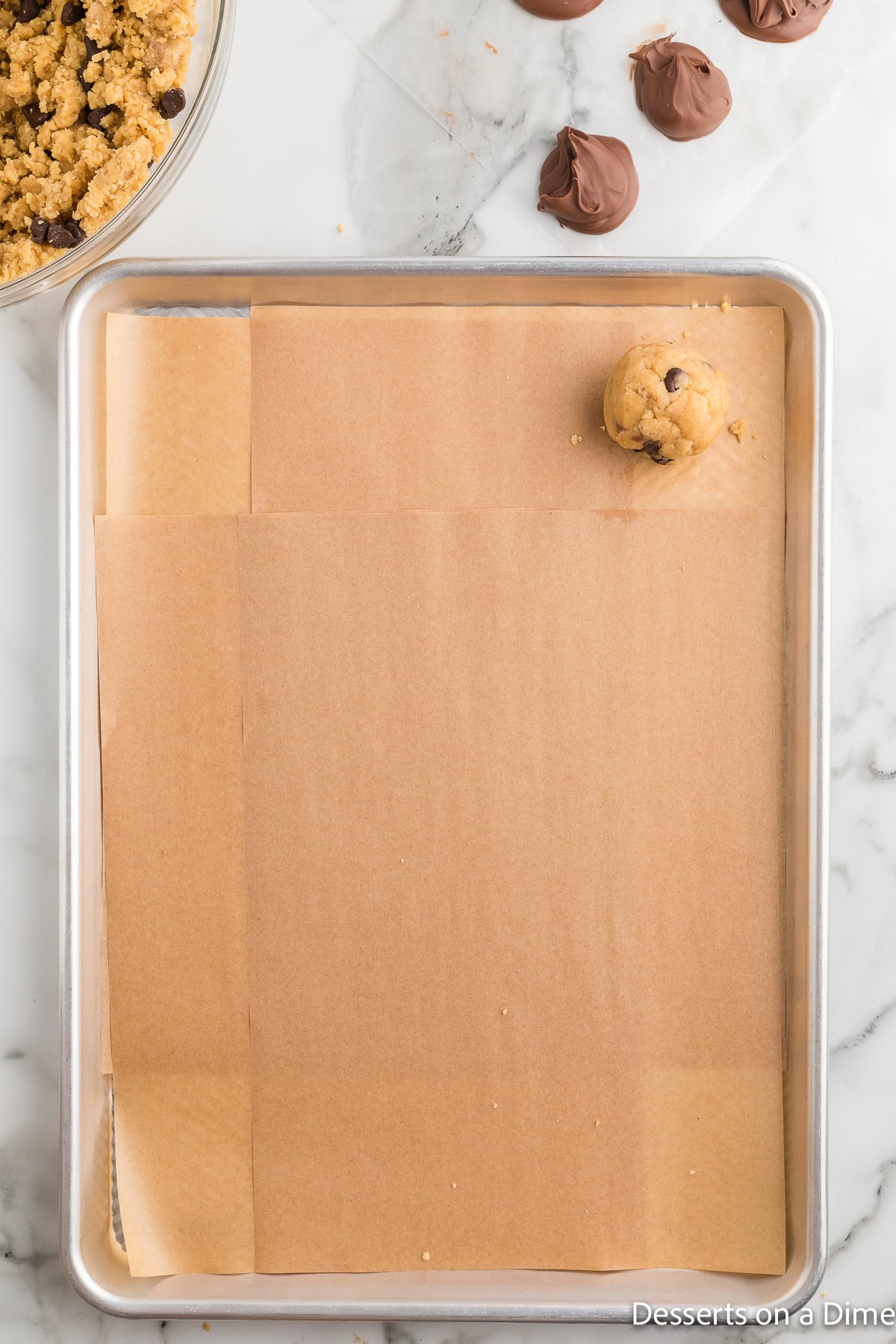 Cookie dough balls placed on baking sheet. 