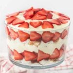 Layers of angel food cake, pudding, strawberries and more make this delicious Strawberry trifle recipe. The dessert looks gorgeous!