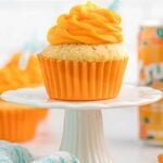 A cupcake on a white cake stand.