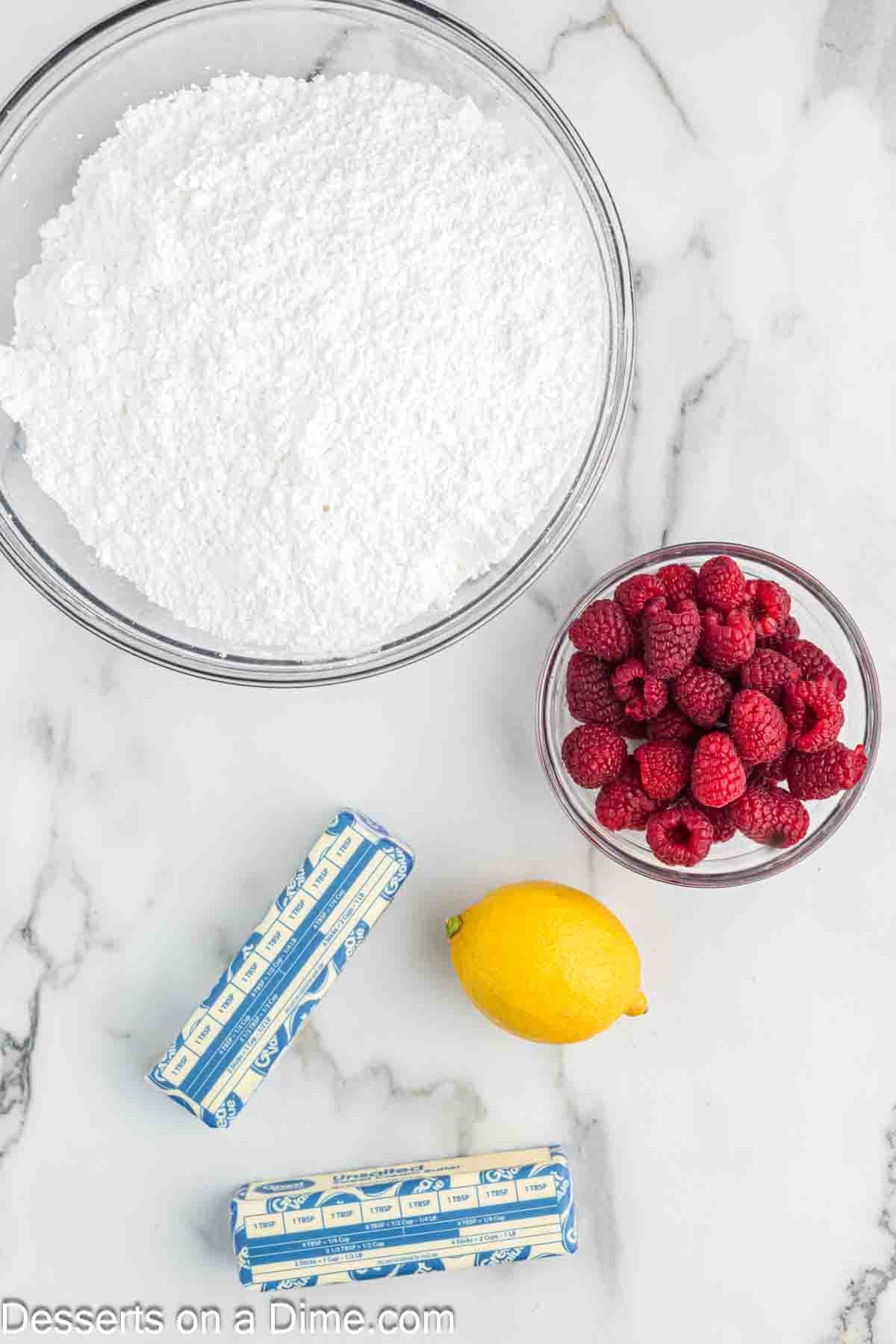 Ingredients for Raspberry frosting - raspberries, lemon, butter, powdered sugar.