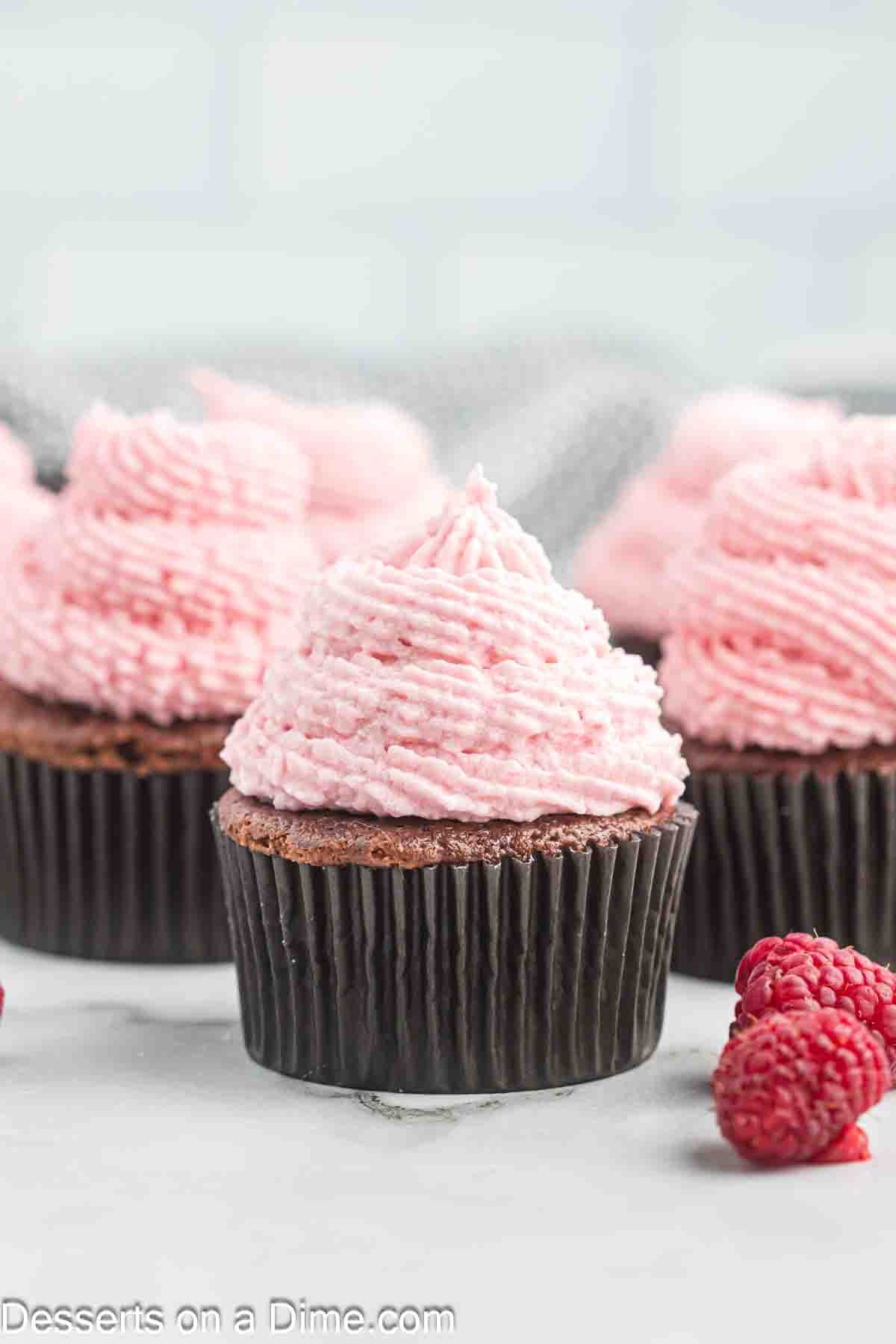 Raspberry frosting on cupcakes.