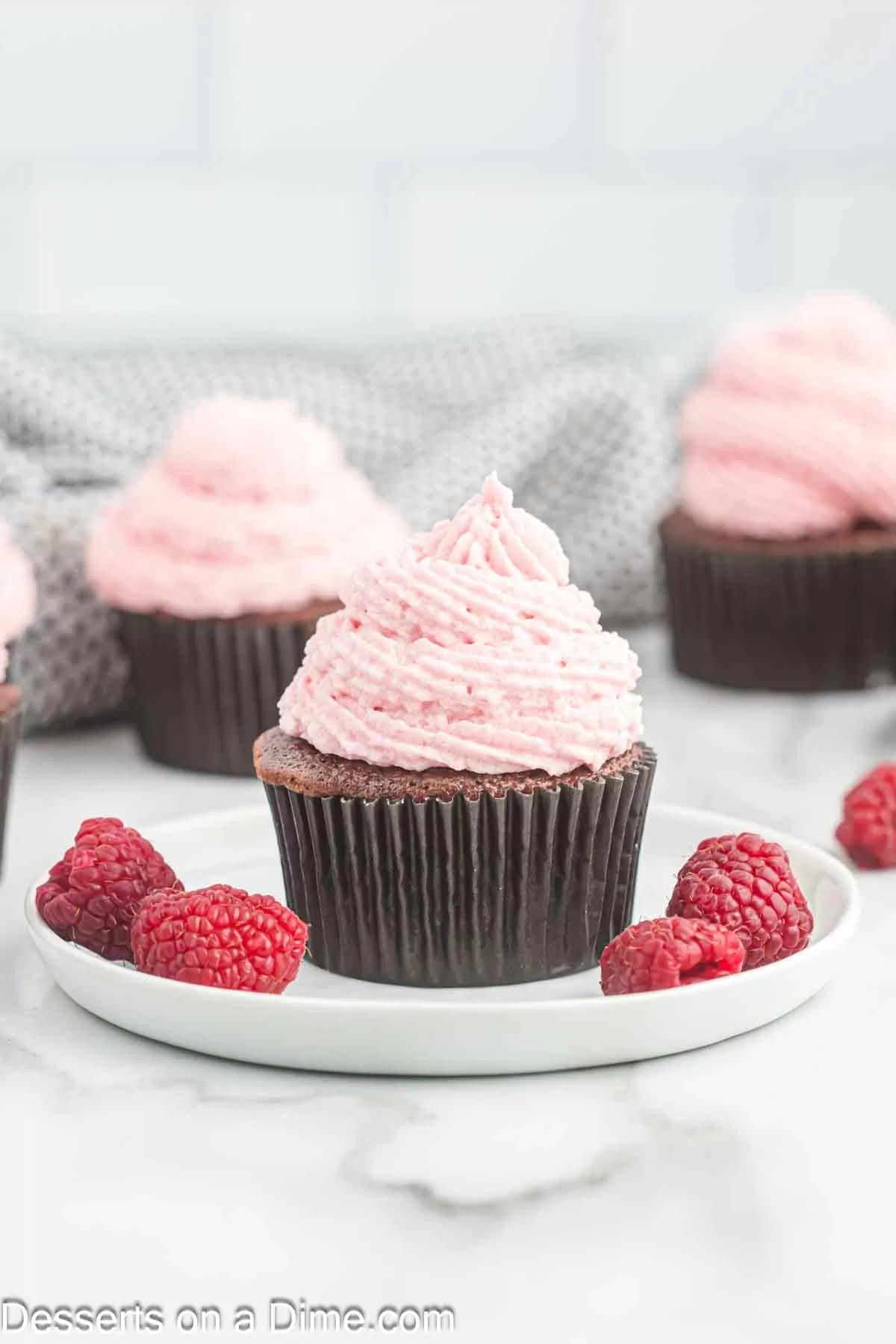 Raspberry frosting on cupcakes.
