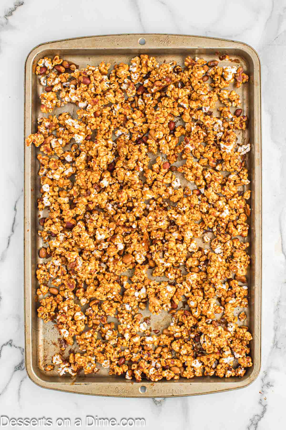 Popcorn spread on baking sheet.