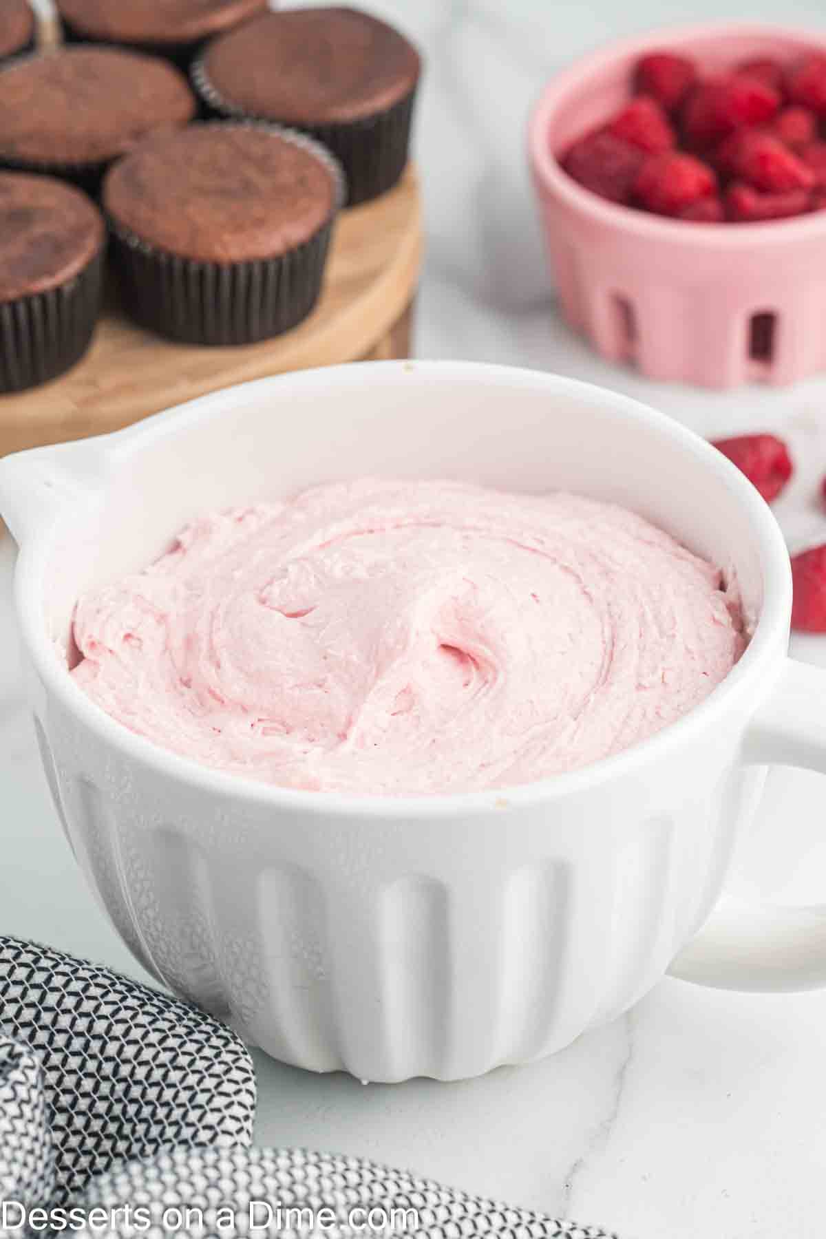 Raspberry frosting in a bowl.