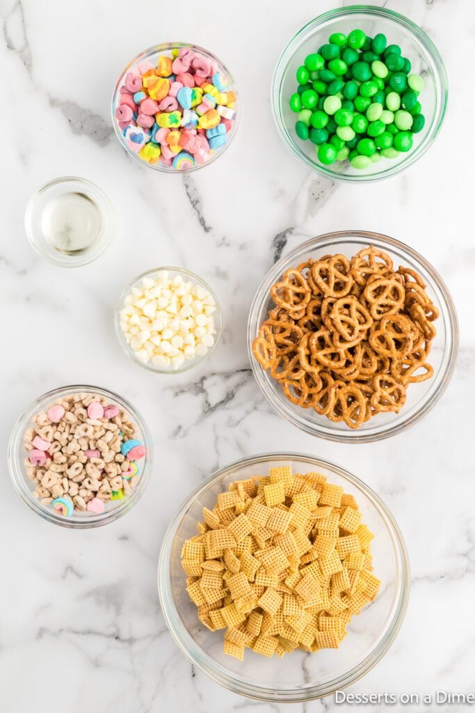 Ingredients for Leprechaun bait - pretzels, lucky charms, chex cereal, M&Ms, white baking chips.