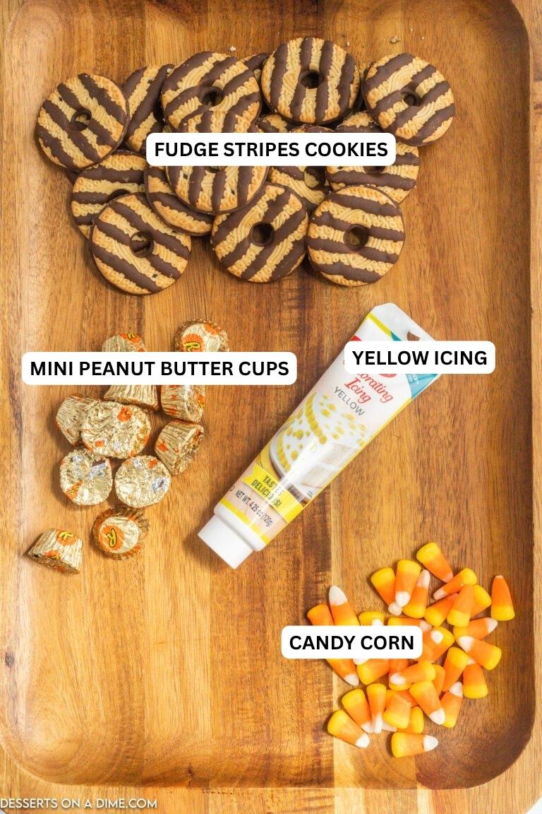 Ingredients for recipe: mini peanut butter cups, yellow icing, candy corn and fudge stripe cookies.