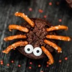 Spider cupcakes with pretzels and candy.
