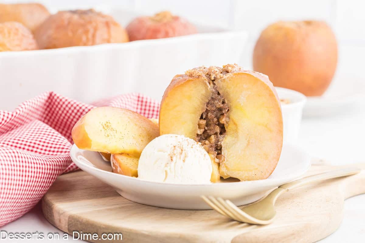 Baked apples with ice cream on a plate.