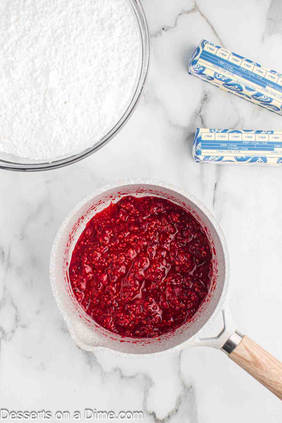Raspberries in a saucepan.