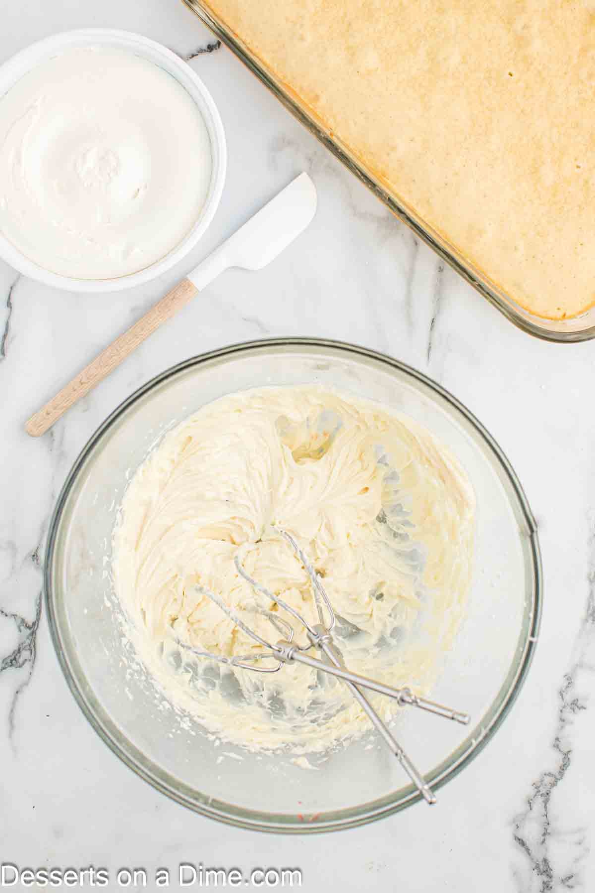 Cream cheese and sugar combined in bowl. 