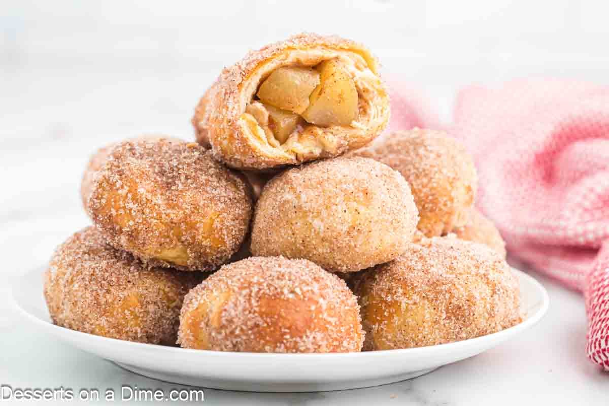 Plate of air fryer apple pie bombs on a white plate.