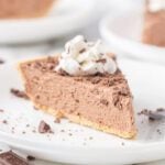 A slice of chocolate pie with whipped cream on top.