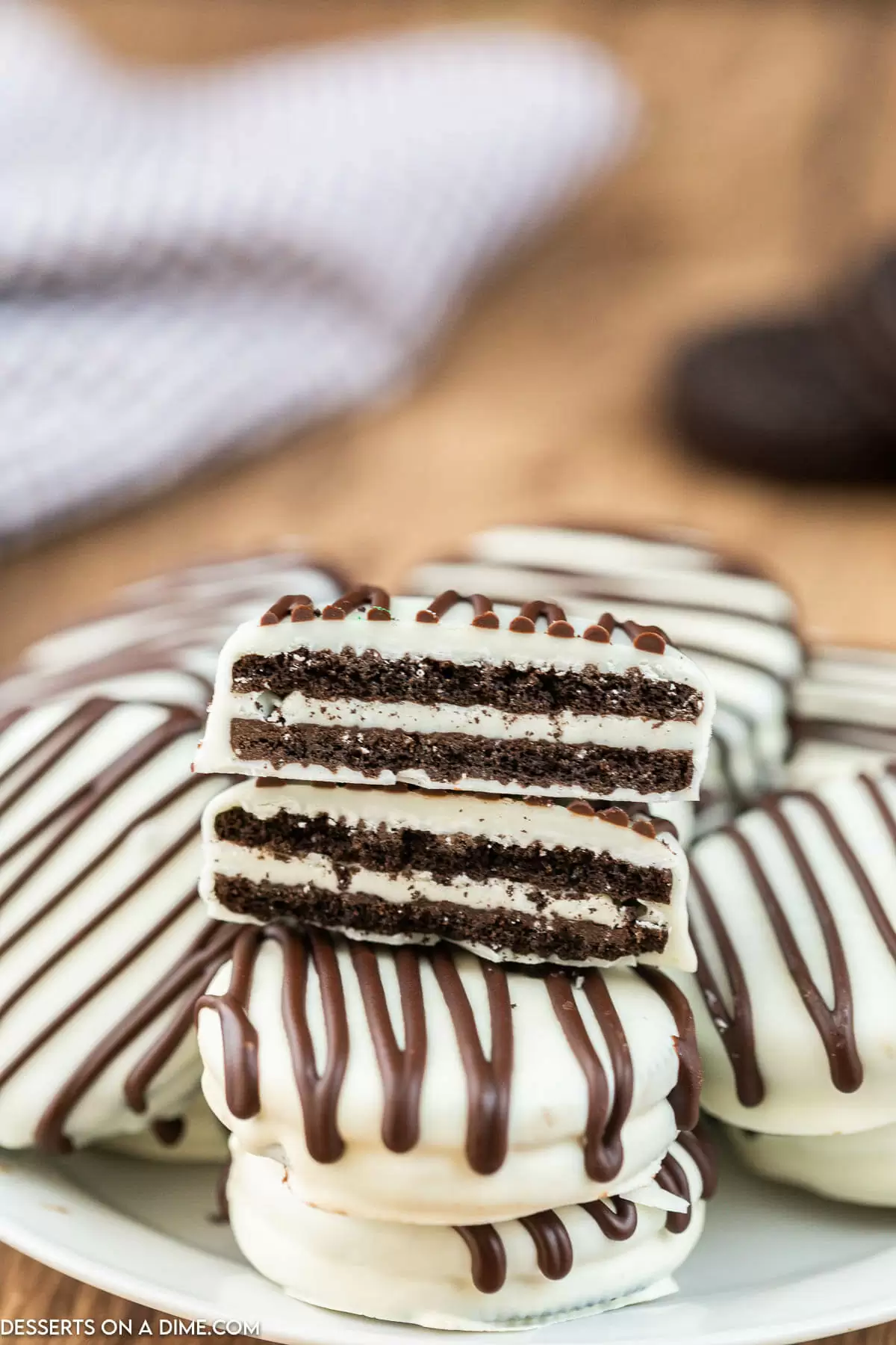 White chocolate oreos stacked together.