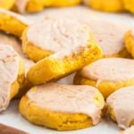 Pumpkin sugar cookies stacked together.