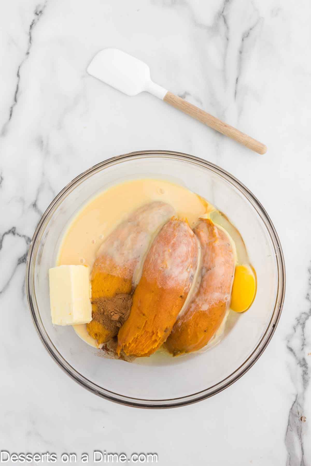 Mixing bowl with sweet potatoes and milk. 