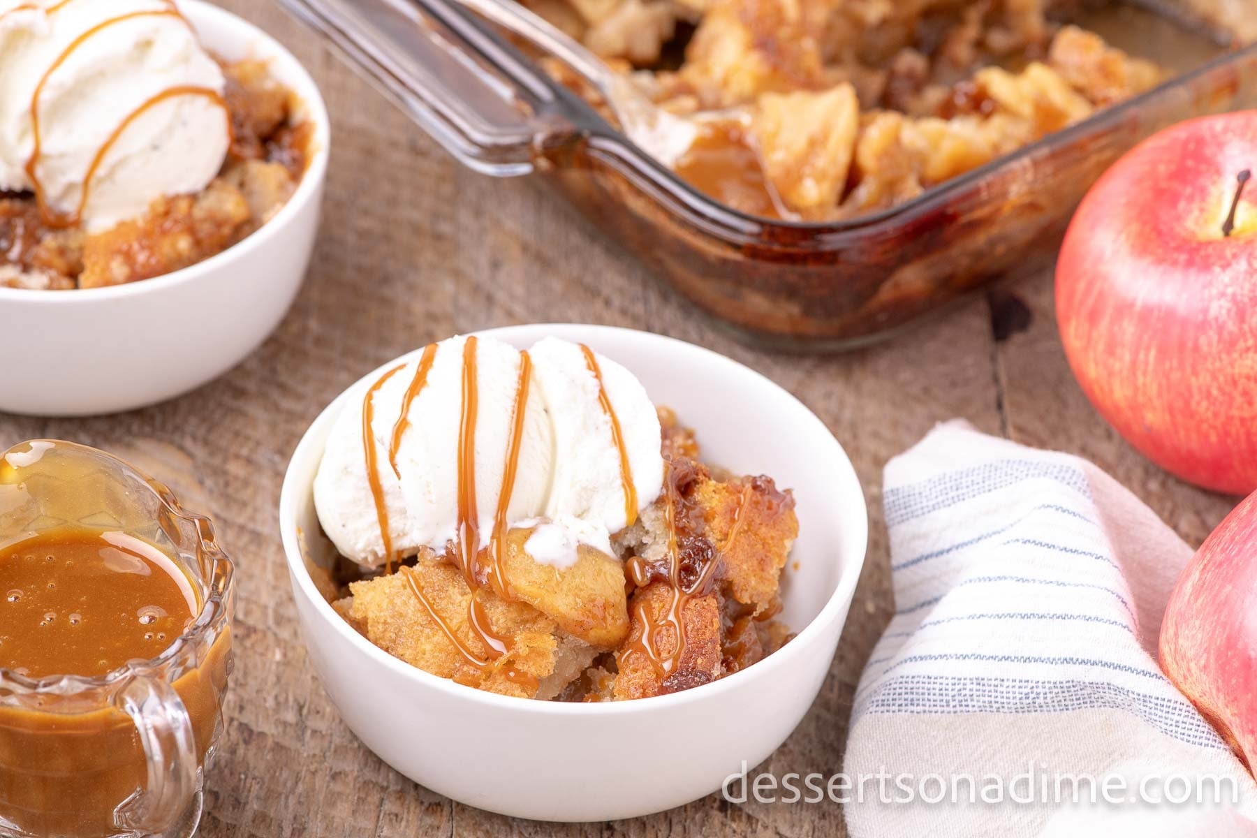 Bowl of caramel apple cobble with ice cream.