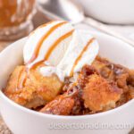 Warm caramel apple cobbler with vanilla ice cream and caramel drizzle on top. Perfect for cozy desserts and easy sweet treats.