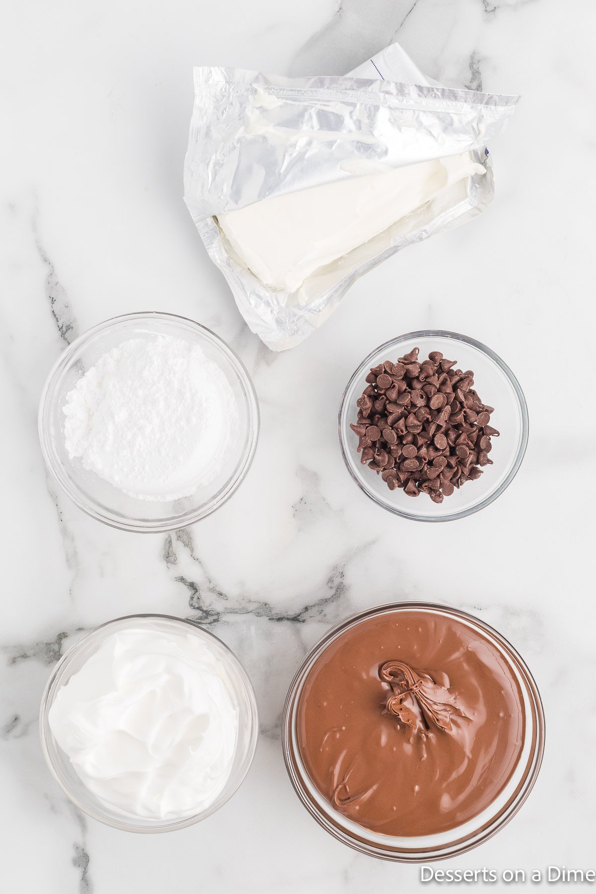 Ingredients for dip - Nutella, powdered sugar, cool whip, cream cheese, chocolate chips