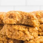 A stack of oatmeal cookies on a white plate.