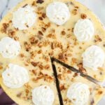 Butter pecan cheesecake being sliced.