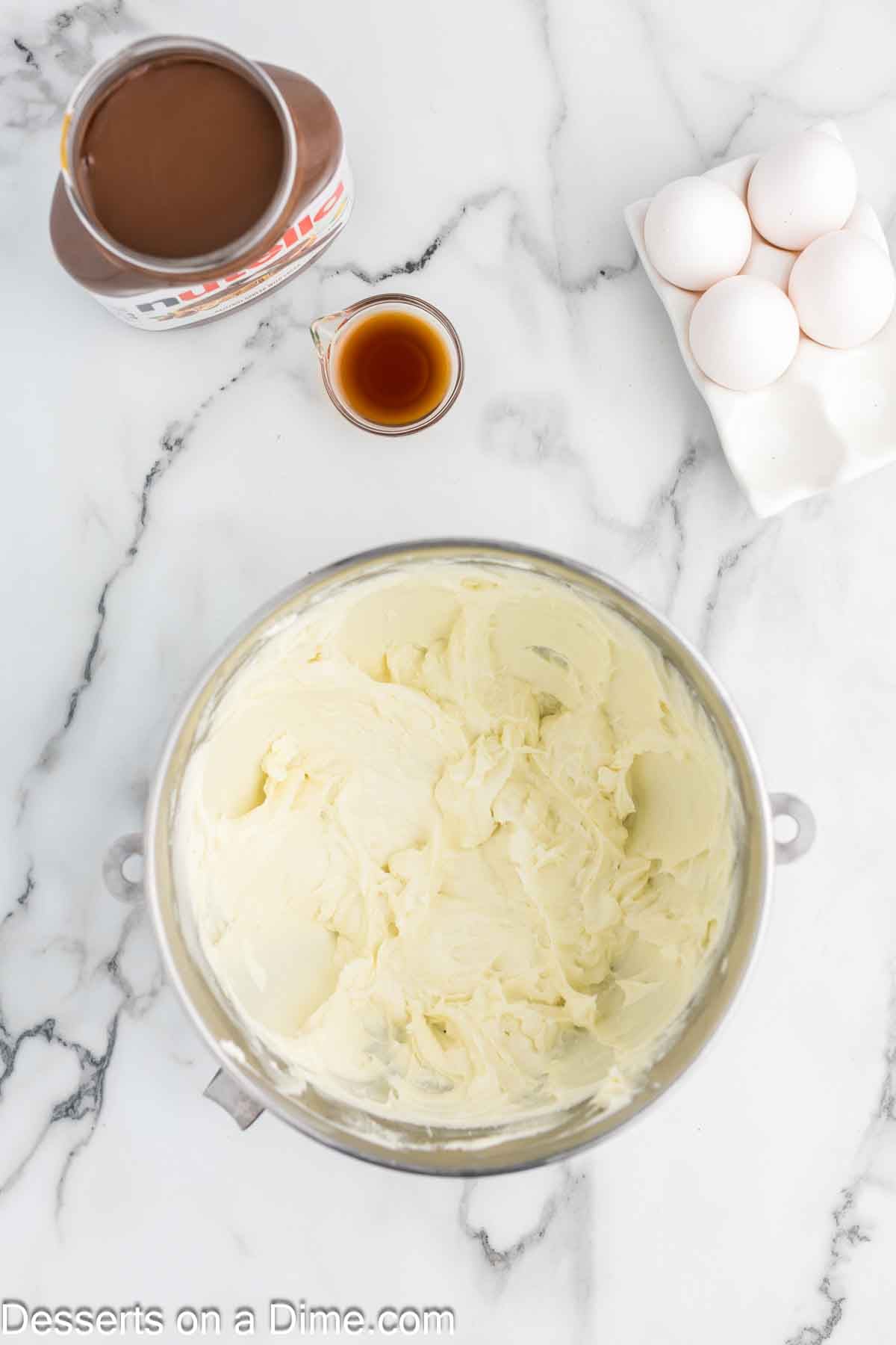 Beating the cream cheese and sugar together in a bowl