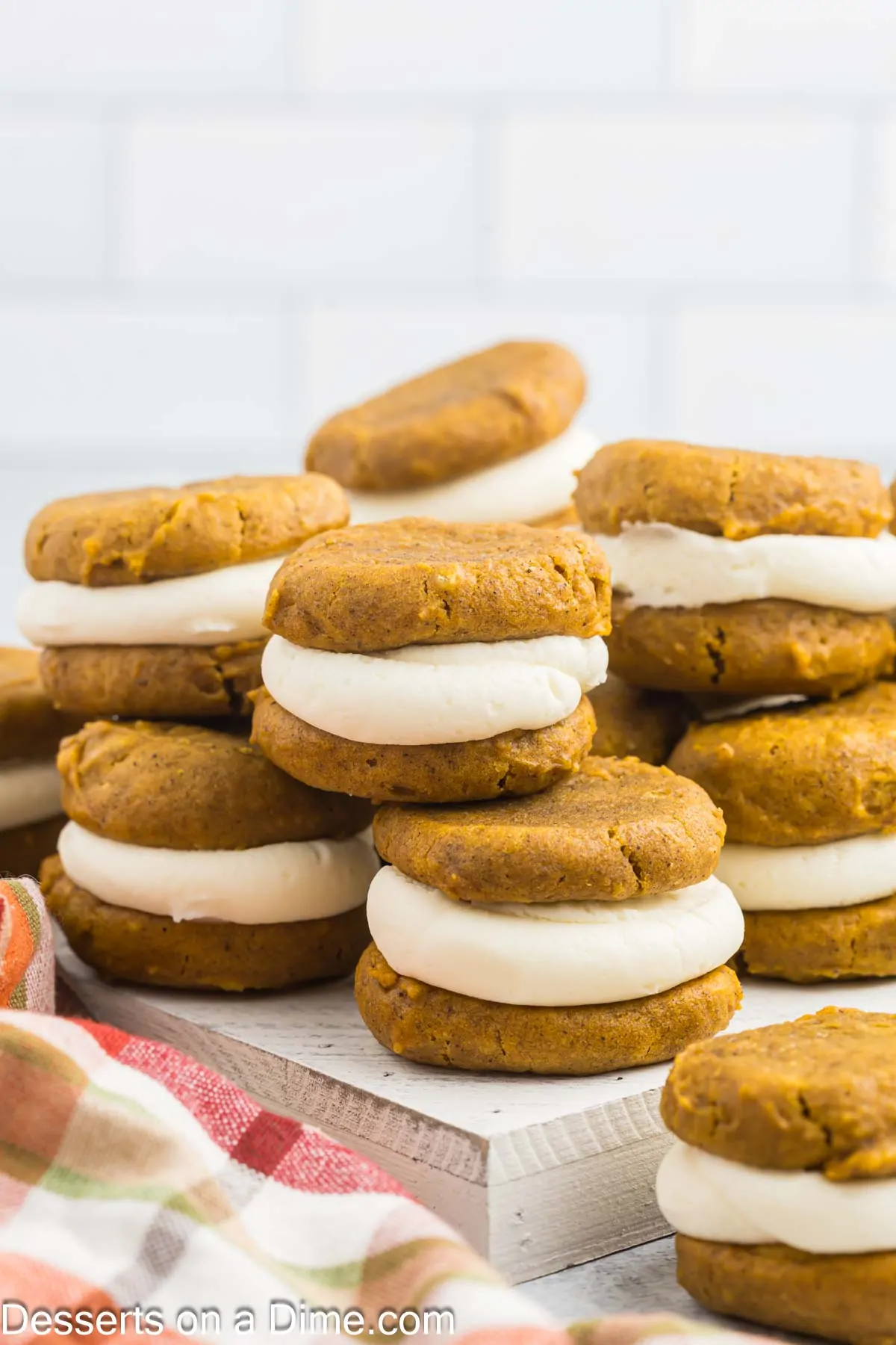 Pumpkin Whoopie Pies stacked together on a platter.