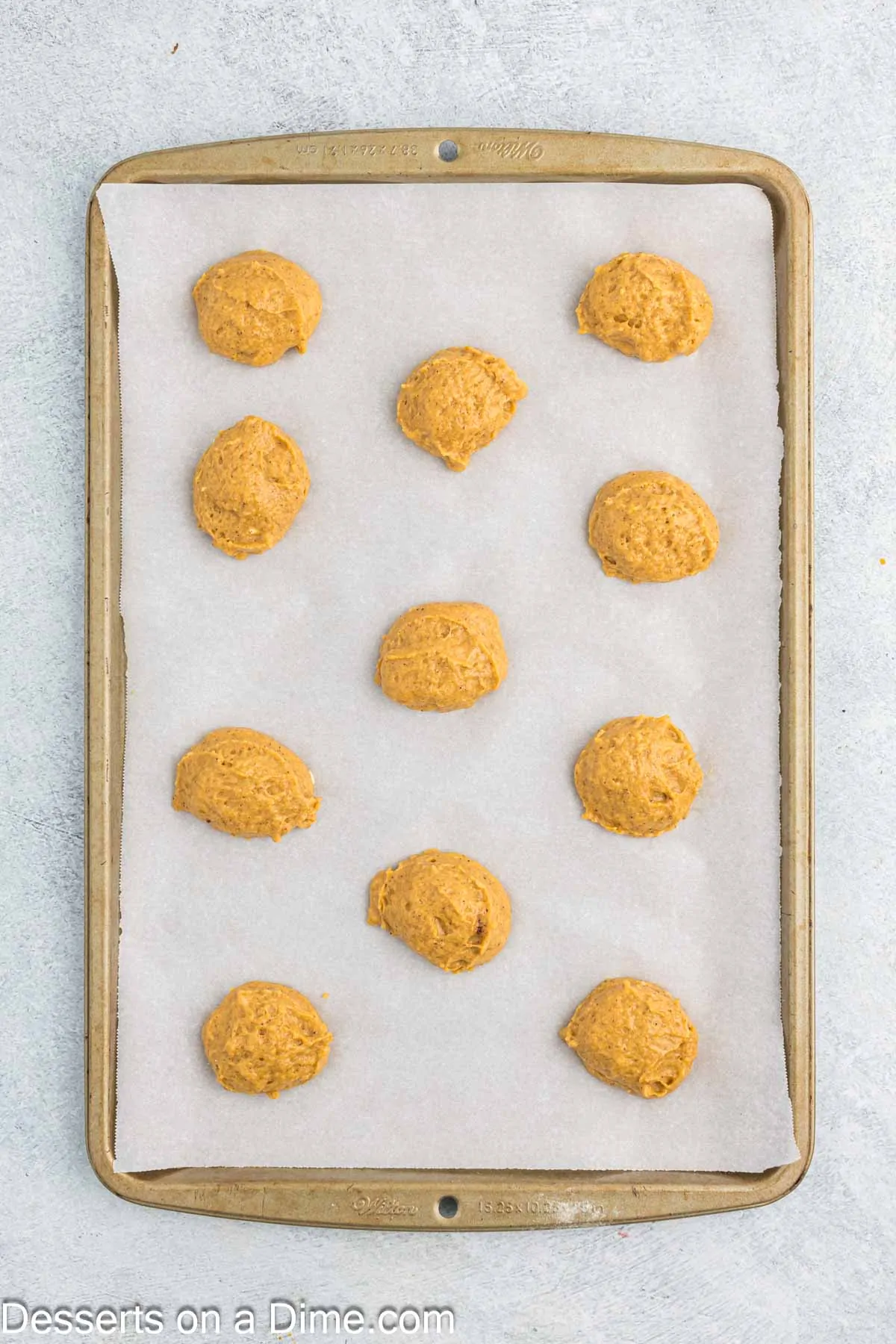 Dough scooped into balls on baking sheet.