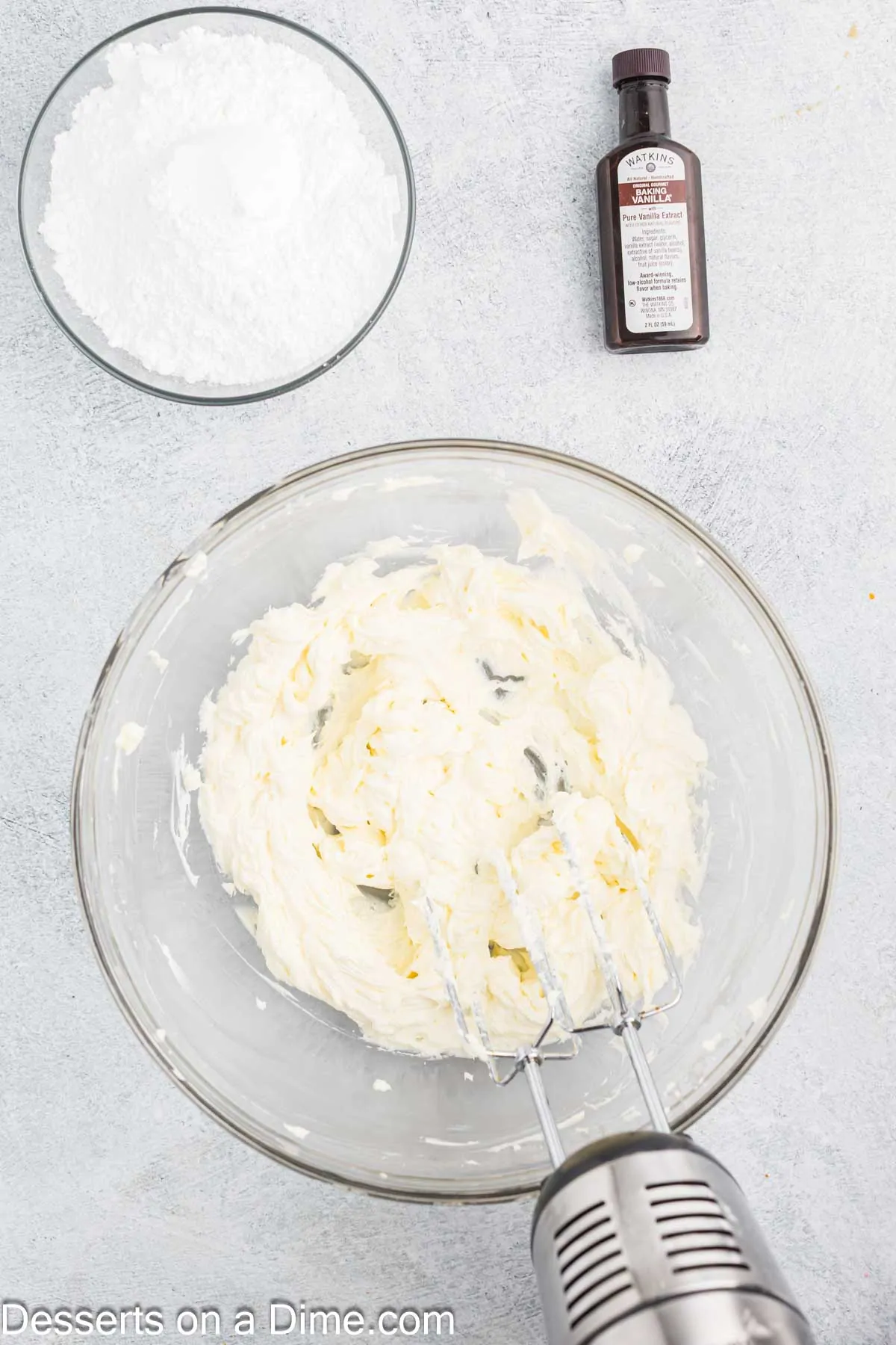 Cream cheese frosting combined in bowl.