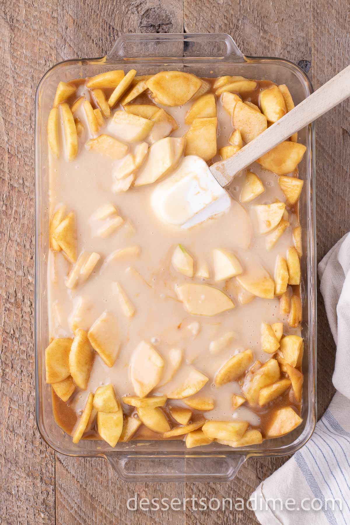 Topping mixture spread over apples in baking dish.