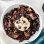 Oreo Dump cake in a bowl topped with ice cream.