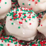 Peanut butter snowballs topped with red and green sprinkles.