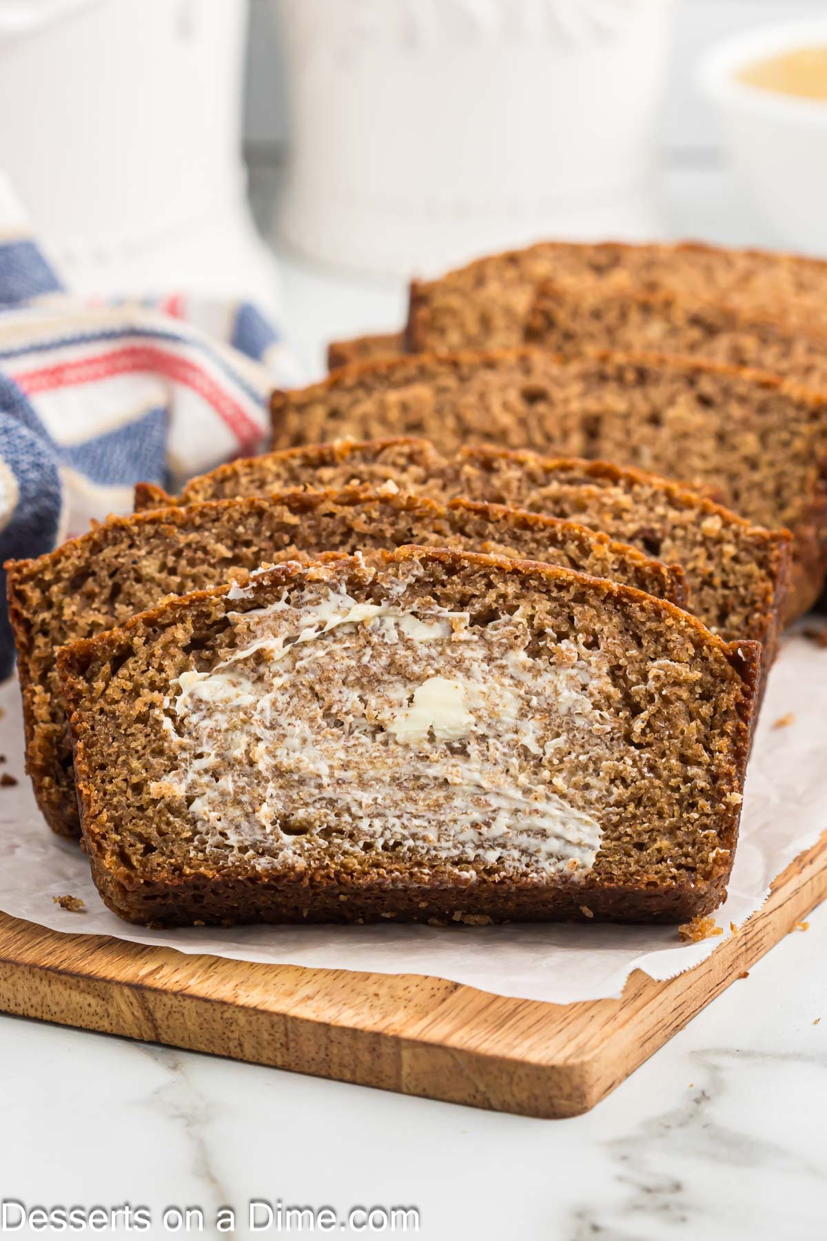 Sliced applesauce bread with butter.