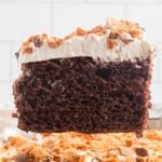 Slice of Butterfinger cake on a plate.