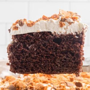 Slice of Butterfinger cake on a plate.