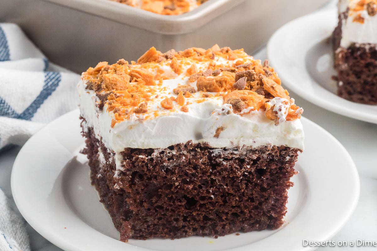 Butterfinger Poke Cake cut into squares.