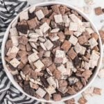 Cookies and cream muddy buddies in a white bowl.